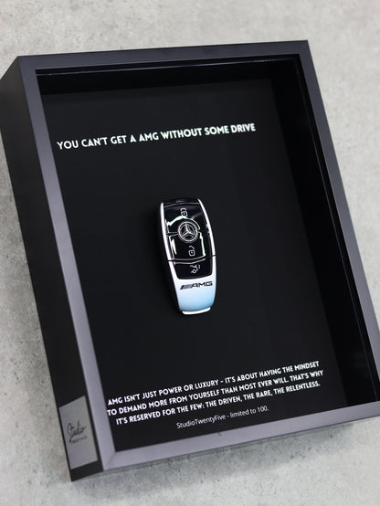 Close-up of AMG key art print showing performance badge and premium frame quality
