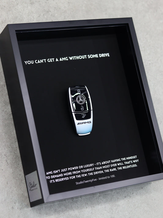 Close-up of AMG key art print showing performance badge and premium frame quality

