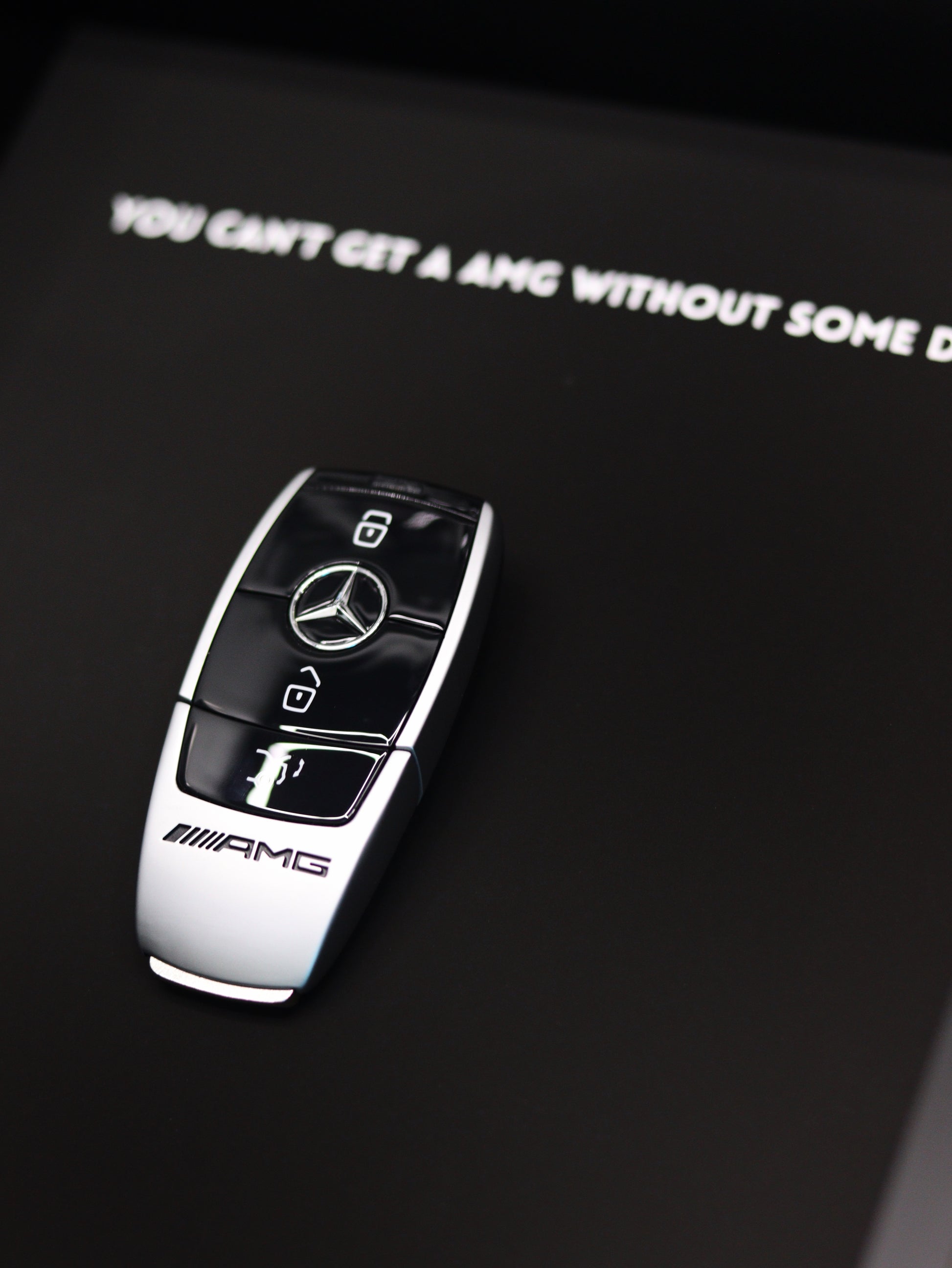 AMG car key art print styled in modern luxury interior setting
